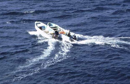 Pirates boats are seen nearby the Chinese ship 